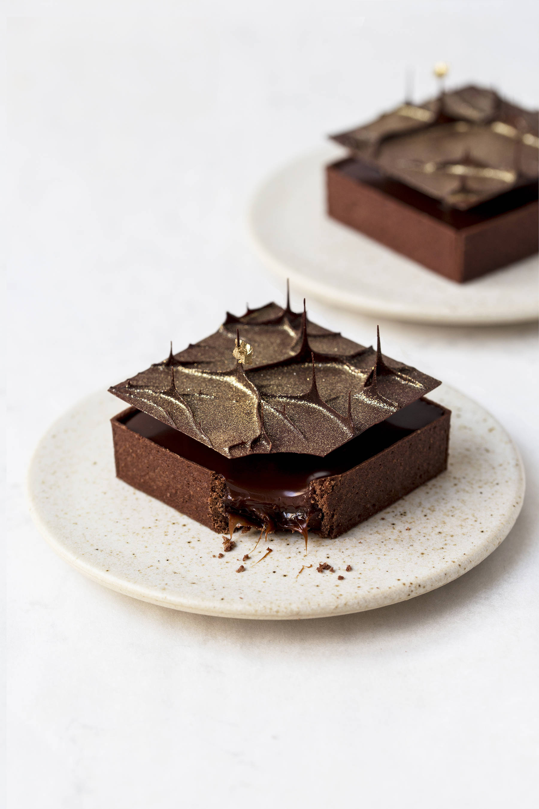 Small chocolate tarts with salted cocoa caramel and chocolate spires