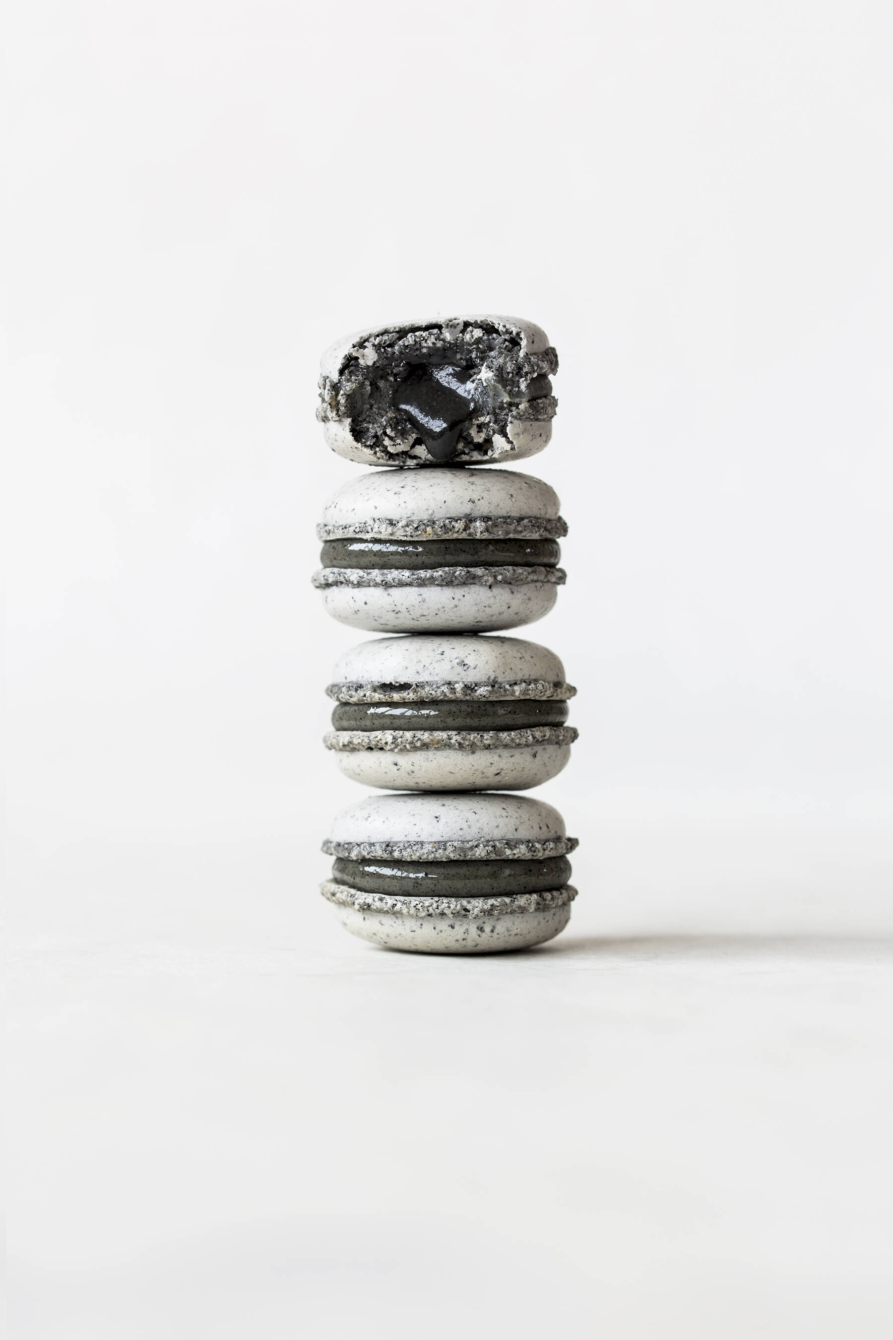 Triple black sesame macarons with white chocolate and lemon